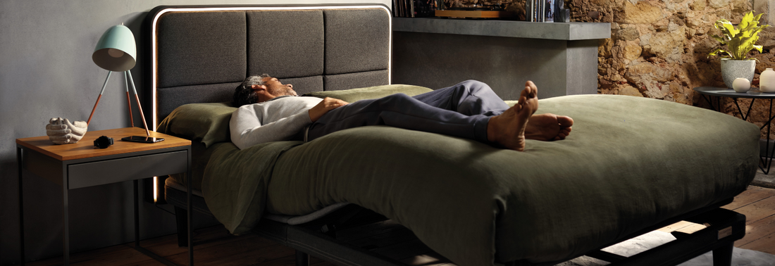 Man lying on the ErgoSportive bed with sheets